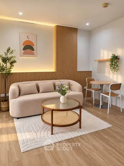 Modern living room with stylish decor, featuring a cozy sofa, elegant coffee table, and ambient lighting.