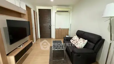 Modern living room with sleek furniture and large TV, perfect for relaxation.