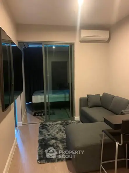 Cozy modern living room with gray sectional sofa and wall-mounted TV