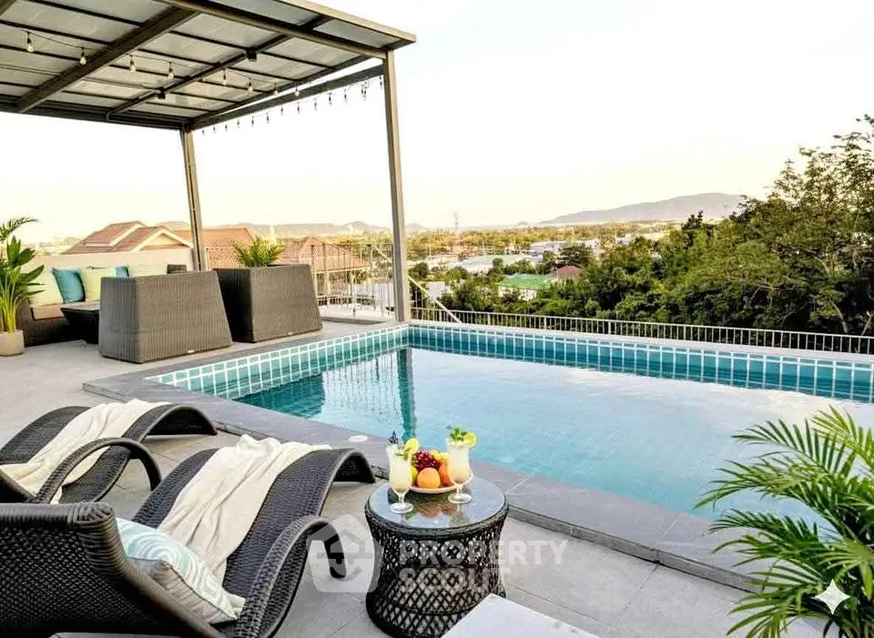 Luxurious rooftop pool with stunning panoramic views and elegant outdoor seating.