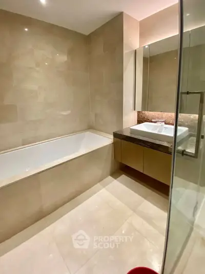 Luxurious modern bathroom with elegant beige tiles and sleek fixtures