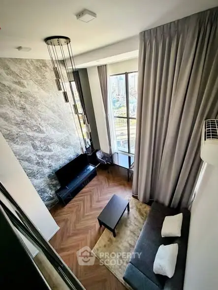 Modern high-ceiling living room with large windows and stylish decor