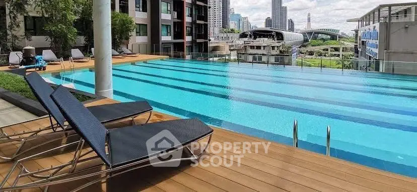 Luxurious urban apartment with rooftop pool and city skyline view.
