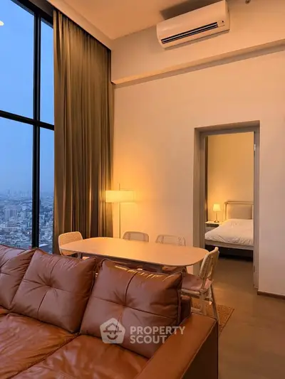 Luxurious high-rise apartment with stunning city view, featuring elegant living room and cozy bedroom.