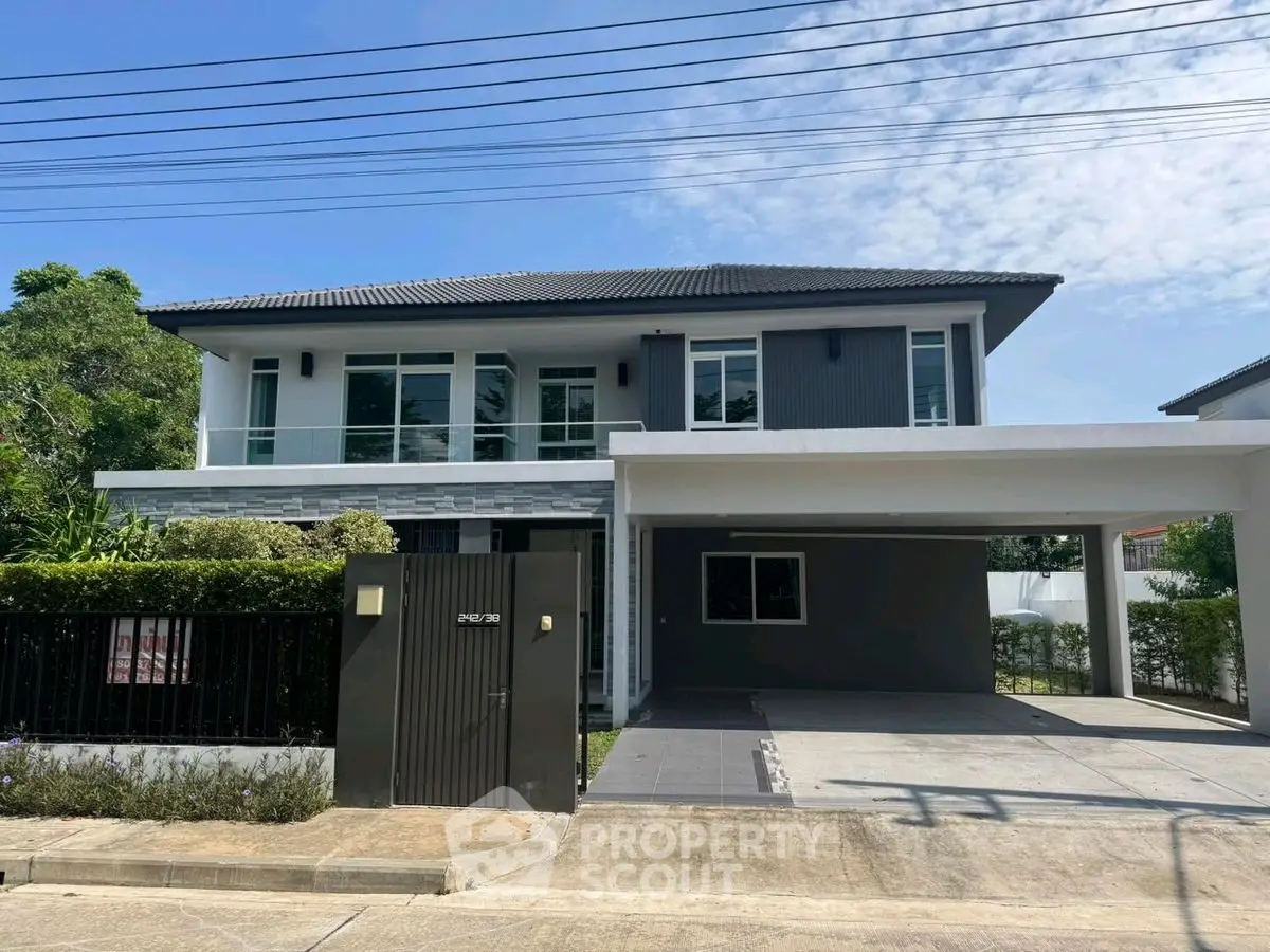 Modern two-story house with spacious driveway and lush greenery, perfect for family living.