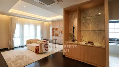 Luxurious living room with elegant decor and large windows in modern apartment.
