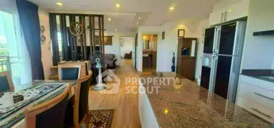 Spacious open-plan living and dining area with modern kitchen and elegant decor.