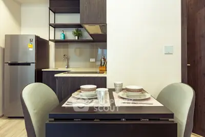 Modern kitchen with dining area featuring sleek appliances and contemporary design.