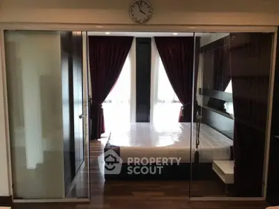 Modern bedroom with glass sliding doors and elegant dark curtains