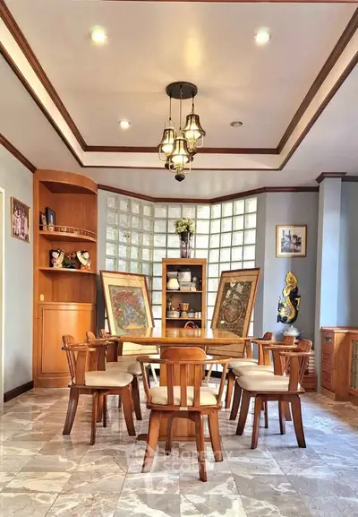 Elegant dining room with wooden furniture and artistic decor in a cozy home setting.
