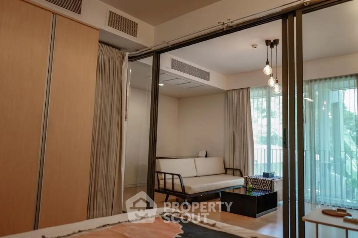 Modern living room with sliding glass doors and stylish lighting