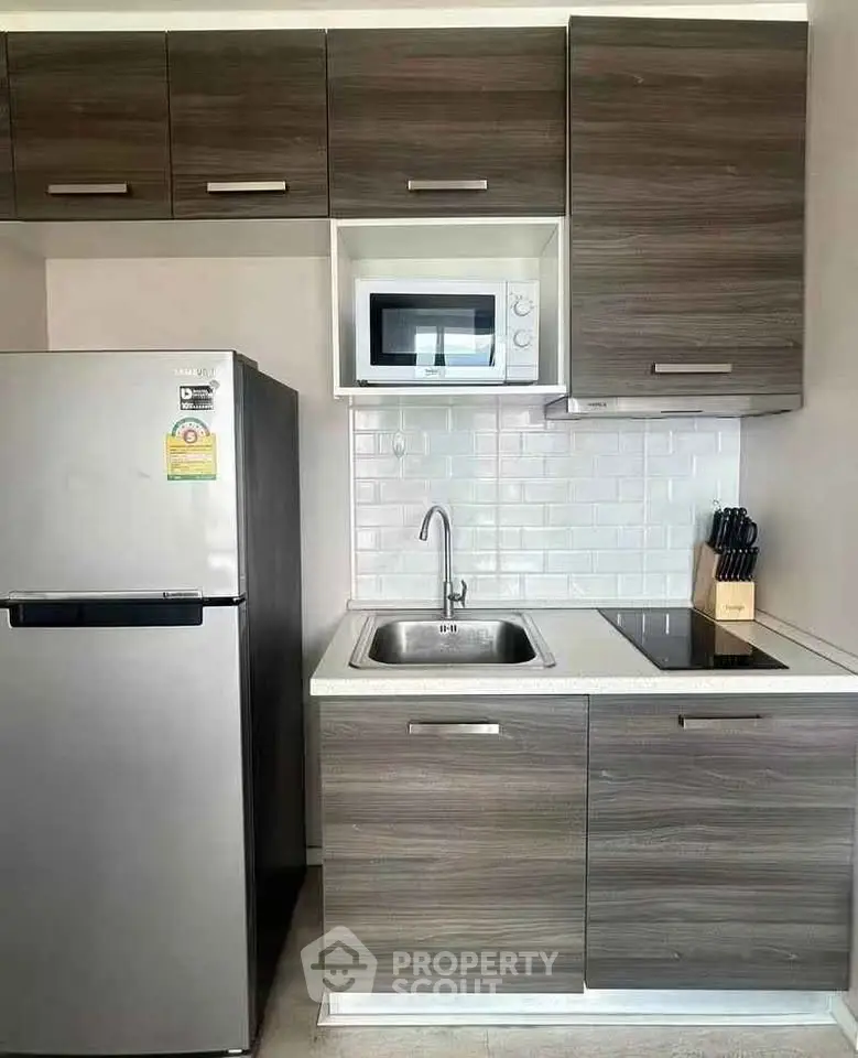 Modern compact kitchen with sleek cabinetry and stainless steel appliances