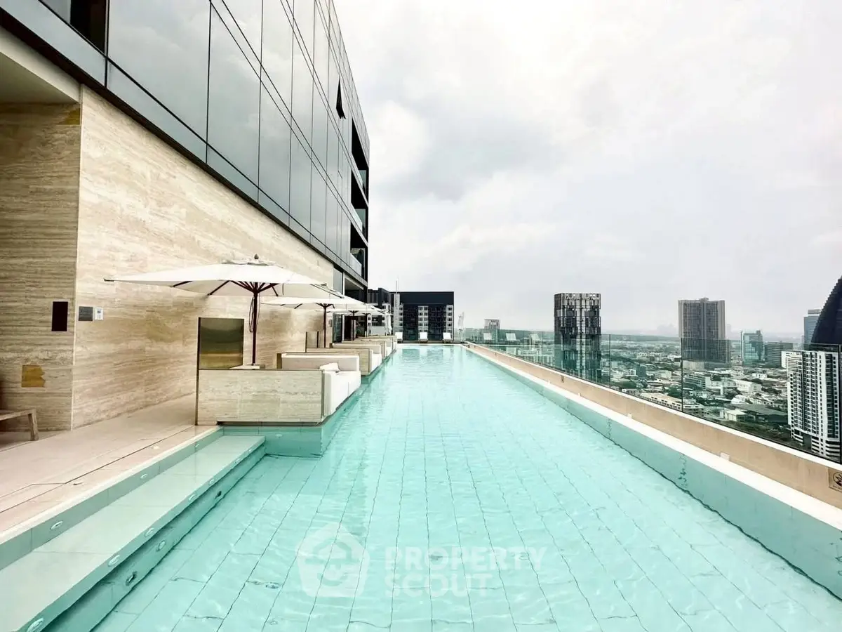 Luxurious rooftop infinity pool with stunning city skyline views in modern high-rise building.