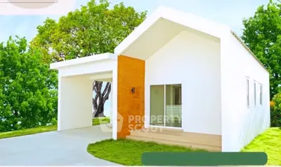 Charming modern white house with lush green surroundings and a sleek carport.