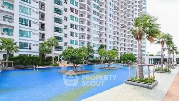 Luxurious condominium with stunning pool and lush landscaping, perfect for modern living.