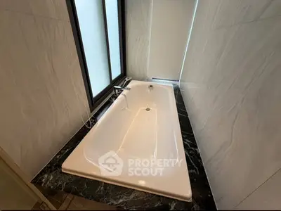 Luxurious bathroom with elegant marble bathtub and modern fixtures