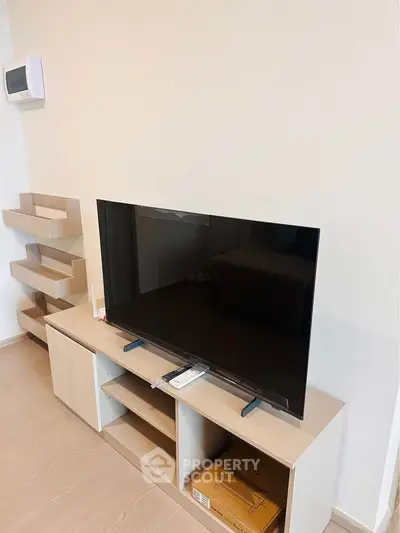Modern living room with sleek TV setup and minimalist shelving
