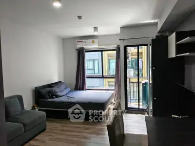 Modern studio apartment with cozy bed and natural light