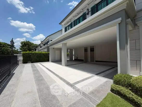 Luxurious modern home exterior with spacious driveway and elegant architectural design.