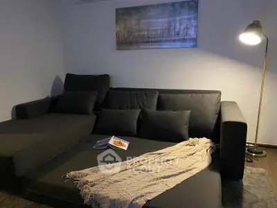 Cozy living room with modern dark sofa and stylish floor lamp