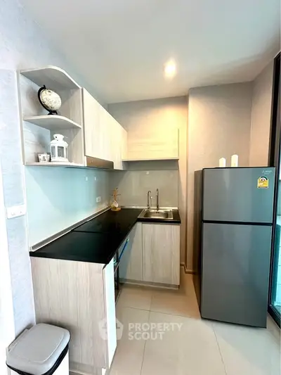 Modern kitchen with sleek design, featuring stainless steel appliances and ample storage space.