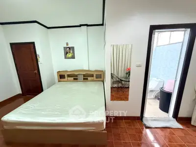 Cozy bedroom with ensuite bathroom and wooden flooring