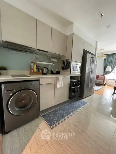 Modern kitchen with sleek appliances and open layout in stylish apartment