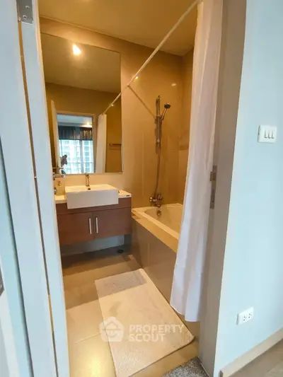 Modern bathroom with bathtub and sleek vanity in stylish apartment