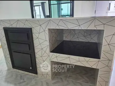 Modern kitchen with sleek geometric tile design and built-in appliances