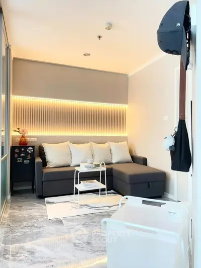 Modern living room with stylish lighting and cozy sofa in a chic apartment.