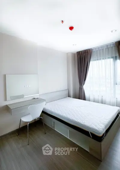 Modern minimalist bedroom with natural light and sleek furnishings