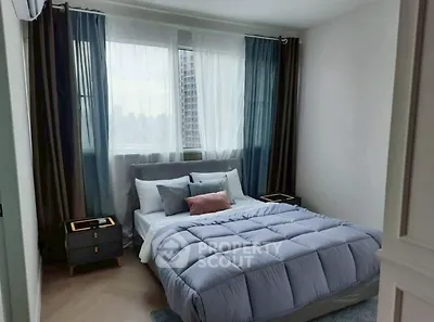Cozy bedroom with modern decor and city view, perfect for relaxation.