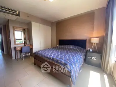 Spacious bedroom with modern decor and natural light