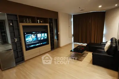 Modern living room with sleek entertainment center and cozy seating area.