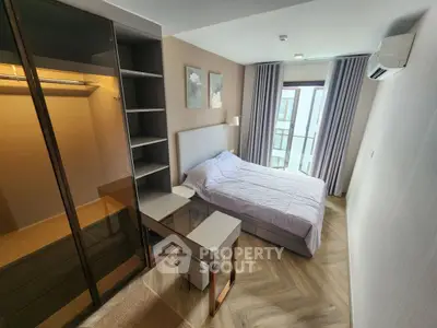 Modern bedroom with stylish decor, large window, and built-in closet in a contemporary apartment.