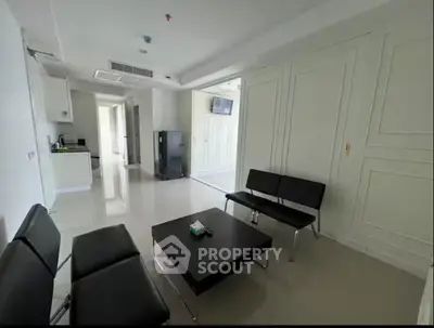 Modern living room with sleek furniture and open kitchen layout