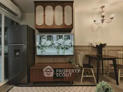 Charming living room with elegant decor, featuring a mounted TV, stylish dining area, and modern appliances.