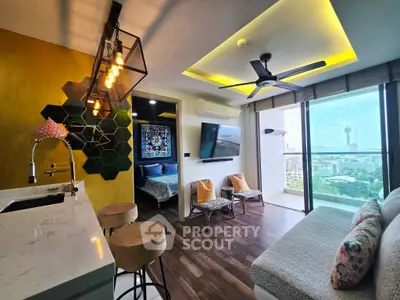 Modern living room with open kitchen, stylish decor, and stunning city view from large windows.