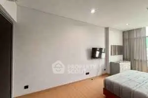 Modern bedroom with wall-mounted TV and stylish decor