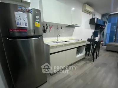 Modern kitchen with sleek cabinets and dining area in stylish apartment