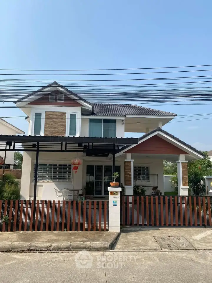 Charming two-story house with modern design and fenced yard in a serene neighborhood.