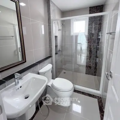 Modern bathroom with sleek fixtures and glass shower enclosure