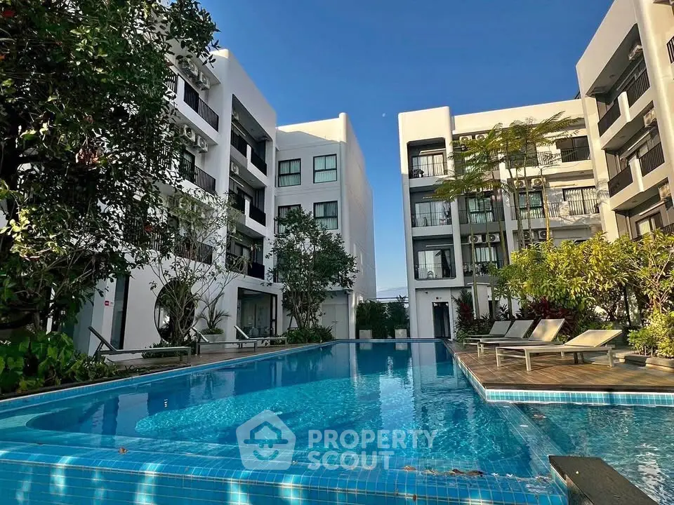 Luxurious apartment complex with a stunning outdoor pool and lush greenery, perfect for relaxation and leisure.