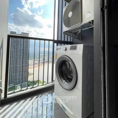 High-rise balcony with washing machine and stunning city view, perfect for urban living.