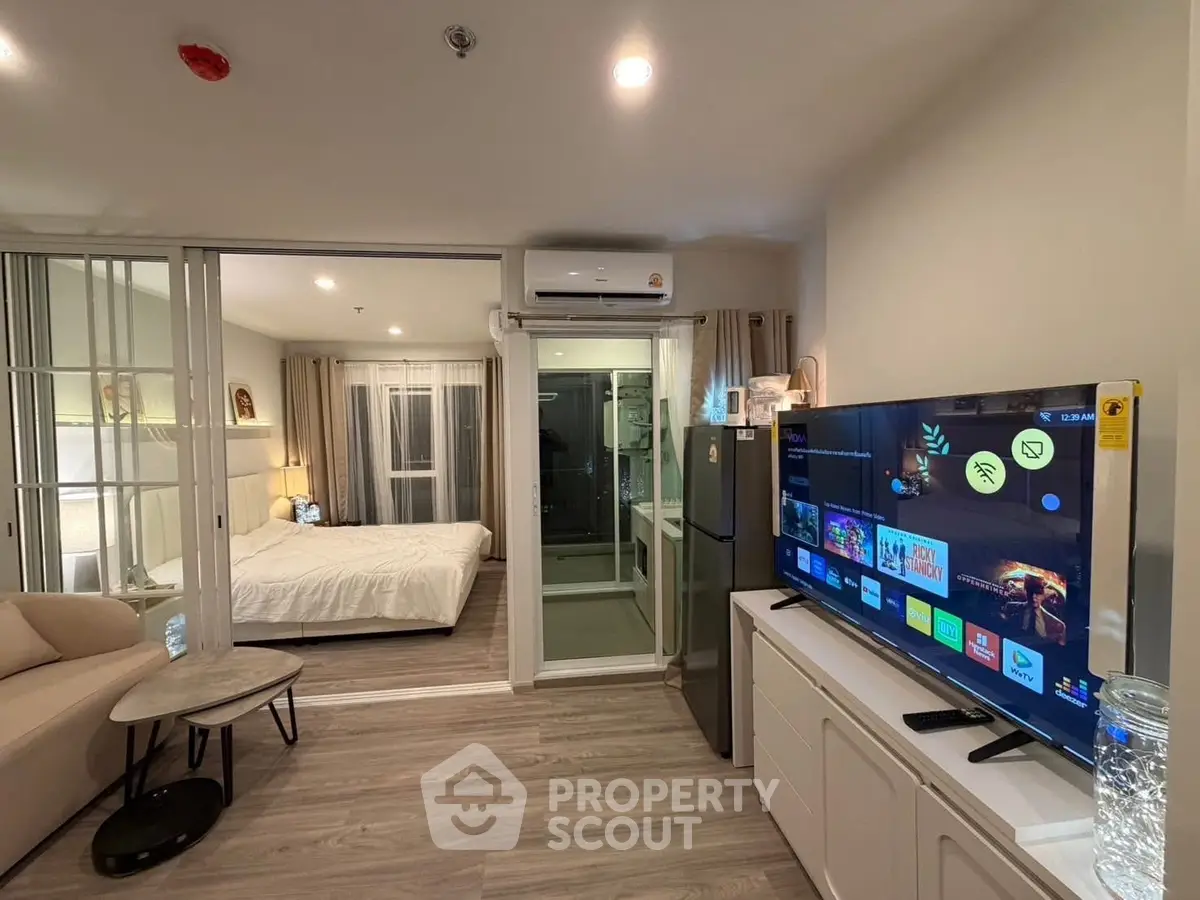 Modern studio apartment with open layout, featuring a cozy living area and bedroom.