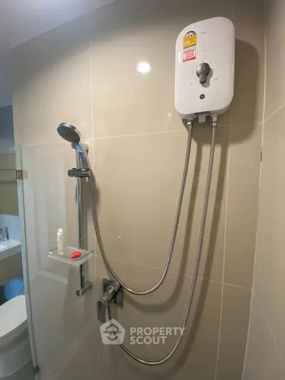 Modern bathroom with sleek shower and water heater, ideal for comfortable living.