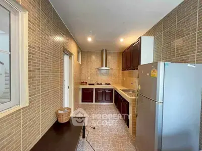 Modern kitchen with sleek cabinetry and stainless steel appliances in a stylish home.