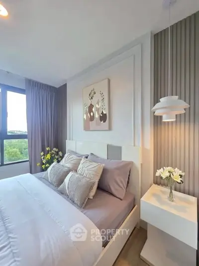 Modern bedroom with elegant decor and large window view