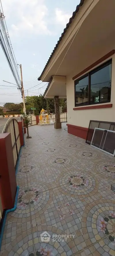 Spacious tiled balcony with decorative patterns and scenic view
