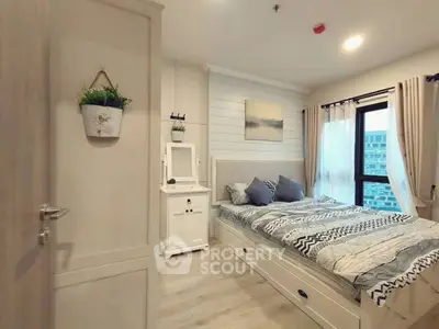 Cozy bedroom with modern decor and large window offering city view